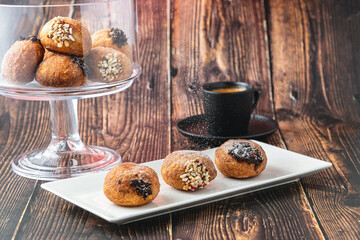 Bombolone or bomboloni is an Italian filled donut and snack food. German donuts - krapfen or berliner - filled with jam and chocolate