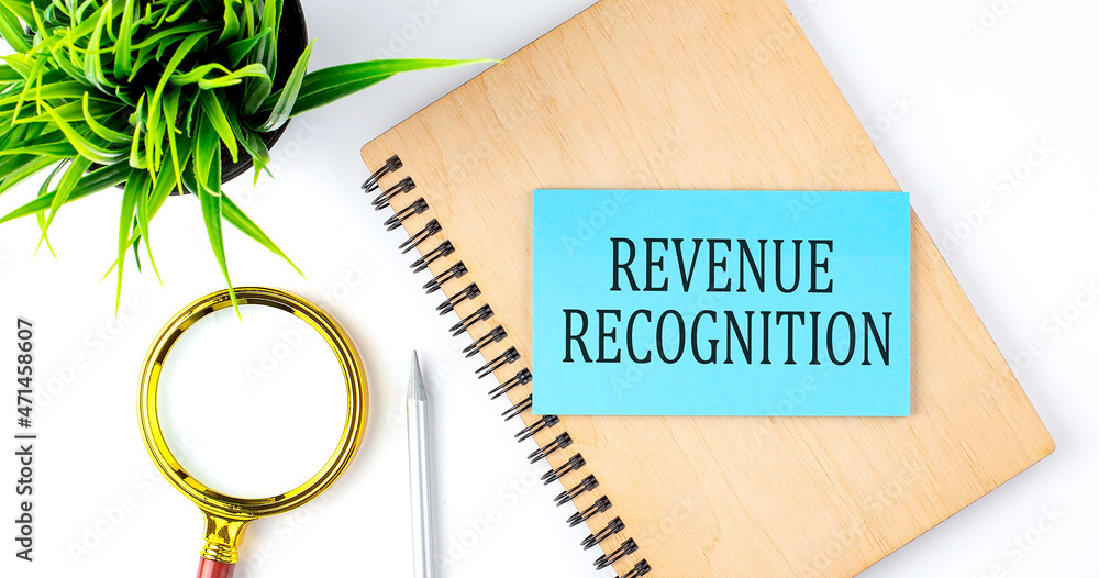 Poster notebook with tools and notes with text on the blue sticker revenue recognition