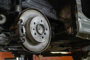 Fototapeta premium Photo of a brake disc and a car caliper. Auto garage. Automobile rapir