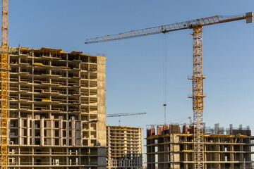 Photo of the construction site and building of high buildings and cranes in the city. Constructional concept