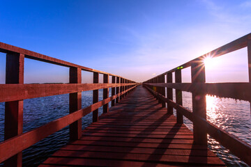 Fototapeta na wymiar Beauty in nature red bridge long way and sunlight in morning landscape 