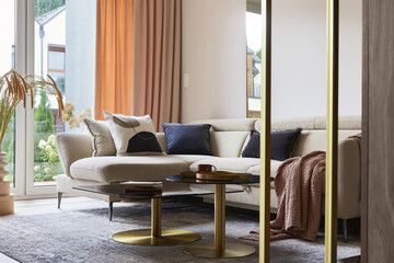 Glamorous living room interior design with modern beige sofa, glass coffee table, red armchair and golden accessories. Template. .