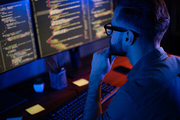 Profile portrait of intelligent minded person hand on chin look two monitors debugging database...