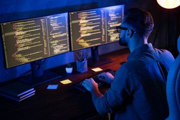Rear photo of smart skilled introvert tester write typing operating data security evening house...