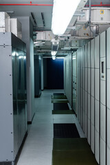 closed servers in data center with fluorescent lamps, cyber security concept