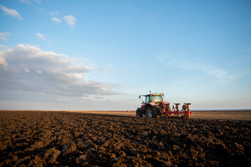 Fototapeta premium Tractor working in the field