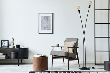 Stylish scandinavian composition of living room with design armchair, black mock up poster frame, commode, wooden stool, lamp, decoration, loft wall and personal accessories in modern home decor.