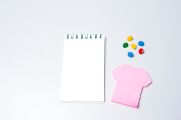 Notebook and pink sticker isolated on white background.Copy space