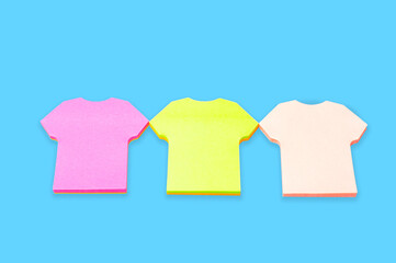 Pink,green and white  t-shirt sticker isolated on blue background.Copy space