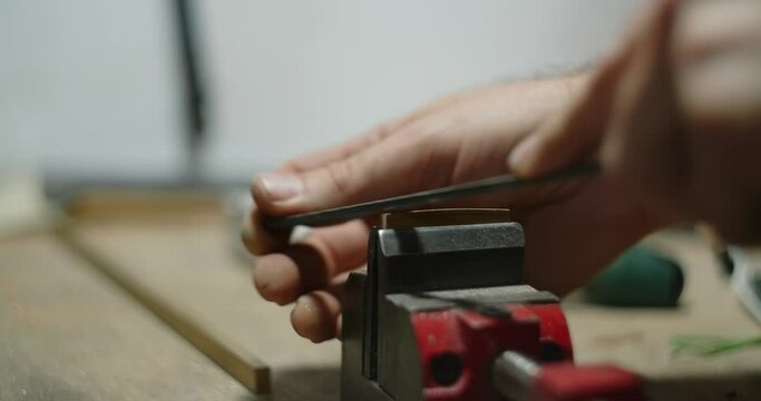 Guitar artisan makes brass guitar nut at workshop. Making the parts fo musical instruments, 4k 60p Prores
