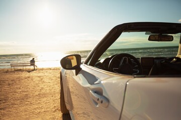 Fototapeta na wymiar Exclusive car on sand road or beach in summer