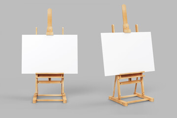 Easel stand board with blank white poster isolated. Wooden easel art painting paper frame stand or poster.White easel stands next to bright grey wall, 3d rendering. 