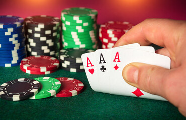 Poker cards with three of a kind or set combination. Close up of gambler hand takes playing cards in poker club