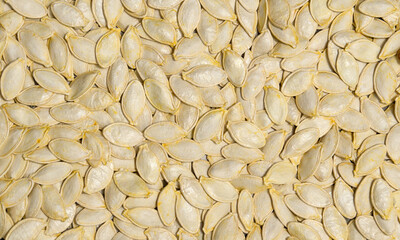Raw superfoods pumpkin seeds after harvest. Pumpkin seed background