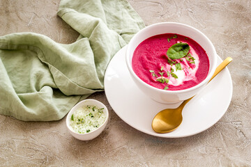 Cream soup made of red beet roots with basil