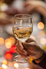holidays, party and celebration concept - close up of man having christmas dinner at home and drinking white wine