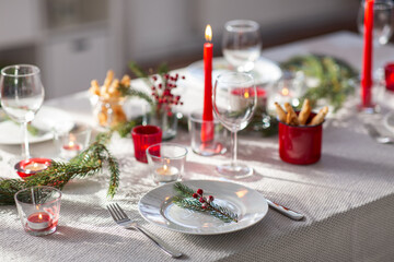 winter holidays, dinner party and celebration concept - close up of christmas table serving at home