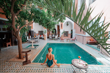 Retreat and vacation. Beautiful young woman relaxing in spa private swimming pool in beautiful...