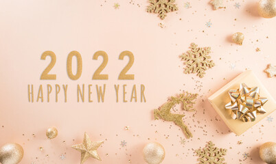 Fototapeta na wymiar Happy New year celebration background concept. Golden gift box, stars, christmas ball and champagne on pastel background.