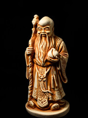 Macro of a small figure of the god Shu (one of the Three Star Elders). Shu is the god of longevity, health and immortality - with a peach in his hand