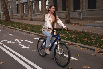 Fototapeta na wymiar Happy beautiful woman with bicycle on lane in city