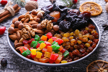 Dried fruits and nuts on a gray background. Christmas composition