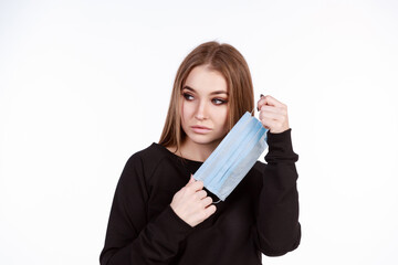 Young girl in a protective mask from the virus on a white background