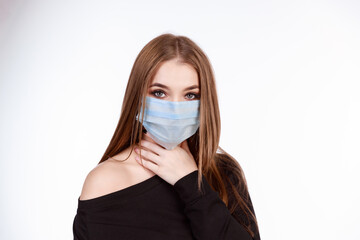 Young girl in a protective mask from the virus on a white background