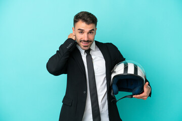 Business caucasian man with motorbike helmet isolated on blue background laughing