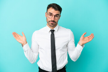 Business caucasian man isolated on blue background having doubts while raising hands