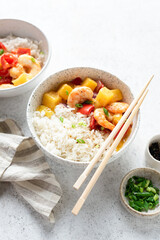 Pineapple shrimps in sweet and sour sauce with white rice in a bowl. Thai cuisine food