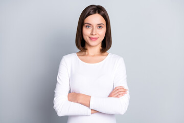 Fototapeta premium Photo of confident charming young lady dressed white clothes smiling arms crosses isolated grey color background