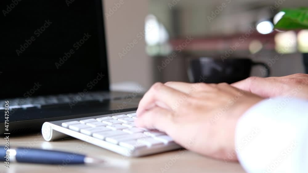 Poster concept of a businessman working on laptop on a desk and typing keyboard