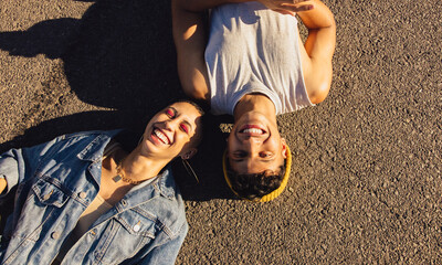 High angle view of two friends lying  down outdoors