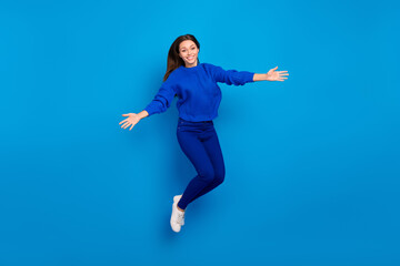 Fototapeta na wymiar Full length body size view of attractive cheery friendly girl jumping hugging having fun isolated on bright blue color background