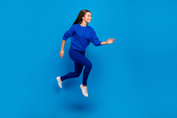 Fototapeta na wymiar Full length body size view of attractive cheerful carefree girl jumping running motion isolated on bright blue color background