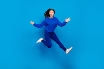 Full length body size view of attractive cheerful funky girl jumping good mood having fun isolated on bright blue color background