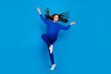 Fototapeta na wymiar Full length body size view of attractive cheery carefree girl dancing having fun jumping isolated on vivid blue color background