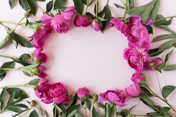 Wreath made of elegant pink peonies flowers with blank mockup copy space on pastel pink background. Flat lay, top view brand, blog, website, social media template