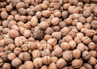 Lots of walnuts. Walnuts background. Close-up. The high content of vitamins and microelements in walnuts nourish the body and restore strength, as well as increase immunity.