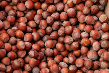 Hazelnut background. Hazelnuts are used in the preparation of sweet dishes - chocolate, sweets, cakes, pastries. Close-up.