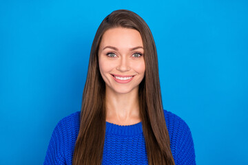 Fototapeta premium Portrait of attractive cheerful content brown-haired girl wearing warm clothes isolated over vibrant blue color background