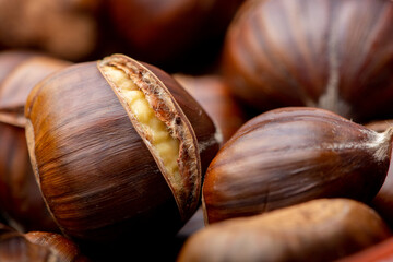 Macro close up of roast chestnuts in a brown bowl