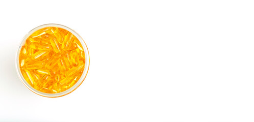Fish oil in gelatin capsules isolate. Omega vitamins in golden colored pills on a blank white...