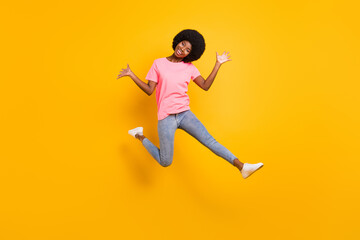 Fototapeta na wymiar Full body photo of funky millennial lady jump wear pink t-shirt jeans isolated on yellow color background