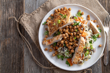 Fitness meal with fried chicken breas, rice, vegetables and roasted chickpeas