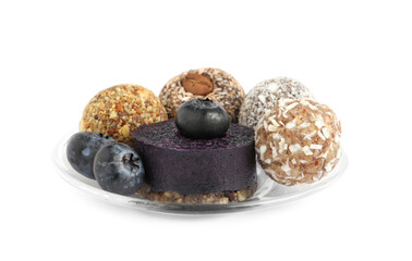 Different delicious vegan candy balls with fruit leather roll and blueberries on white background