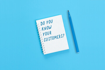 The text "Do you know your customers?" is written on a notebook page