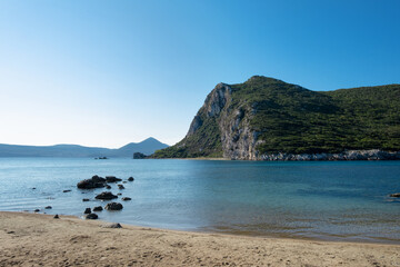 Beautiful blue sea harbor,sandy beach outside Pylos,Peloponnese,Greece, Europe.Mediterranean region.Ionian sea with green mountains on background.Copy space for text