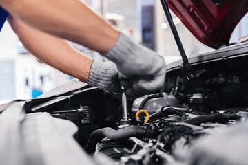 Auto mechanic working in car service garage